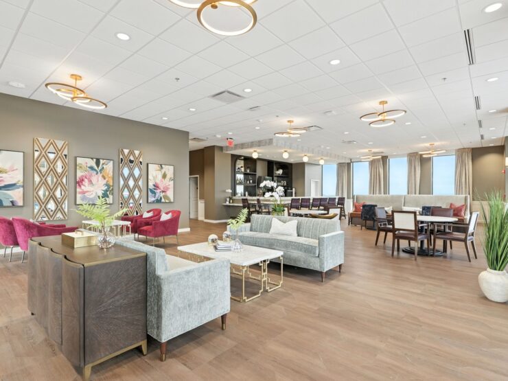 Bright and inviting lounge with comfortable seating, elegant decor, and communal dining areas.