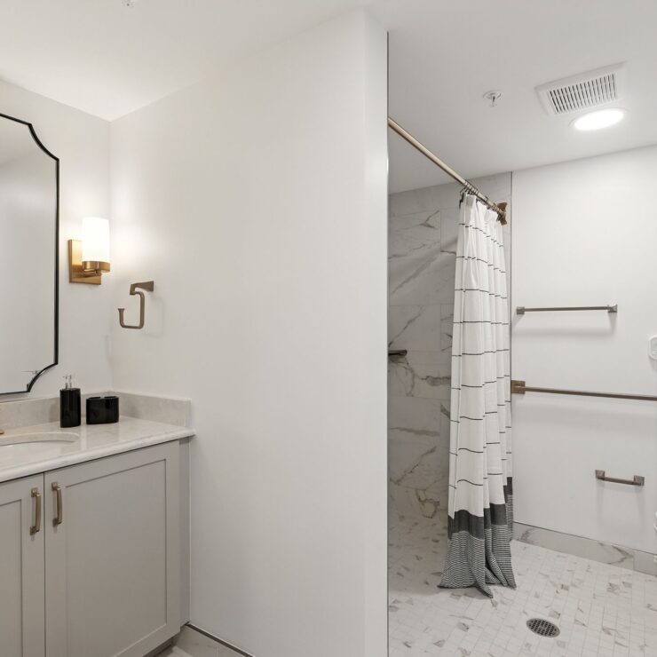 Bright, accessible bathroom with modern fixtures and supportive grab bars for comfort and safety.