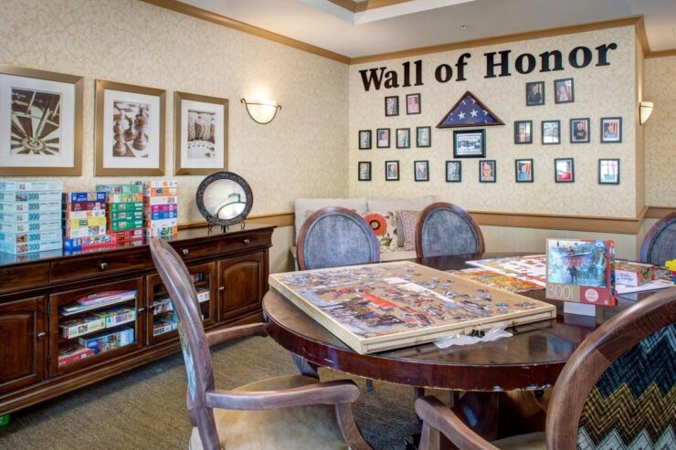 A welcoming game room with puzzles, chess decor, and a Wall of Honor celebrating community members.
