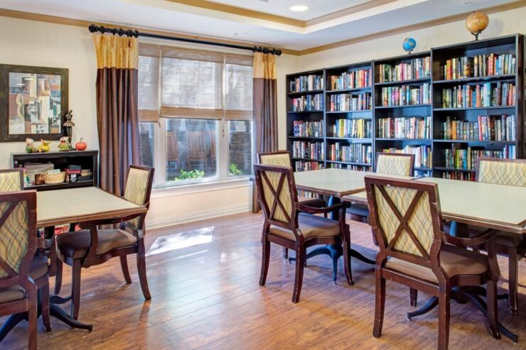 Bright and inviting library space with comfortable seating and shelves filled with books.