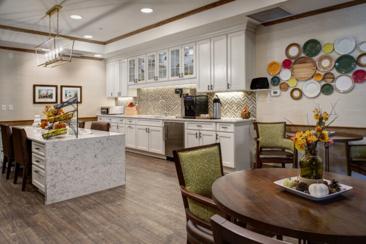 Bright, inviting bistro with communal seating, warm decor, and a welcoming atmosphere for residents.