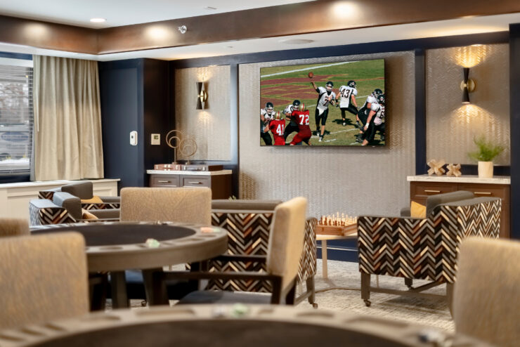 Bright common area with comfortable seating, a large TV, and a welcoming, social atmosphere.