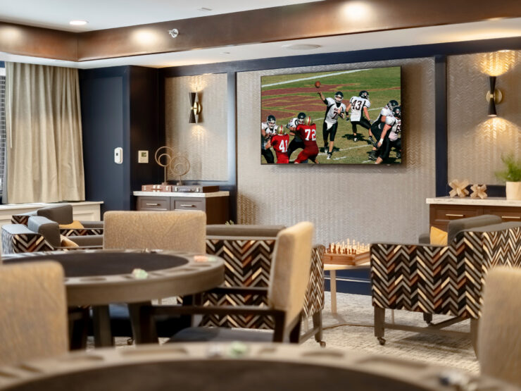 Bright common area with comfortable seating, a large TV, and a welcoming, social atmosphere.