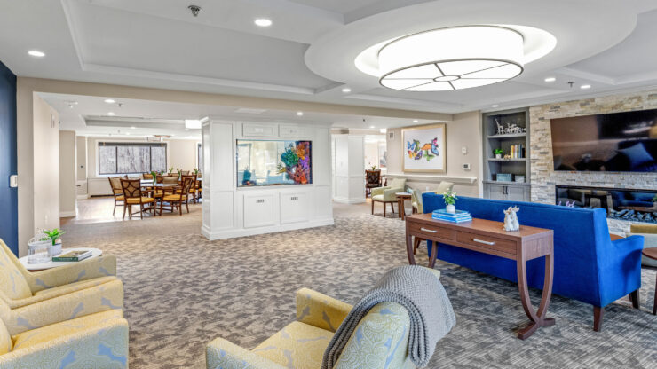 Bright, inviting communal lounge with comfortable seating, large aquarium, and dining area for socializing.