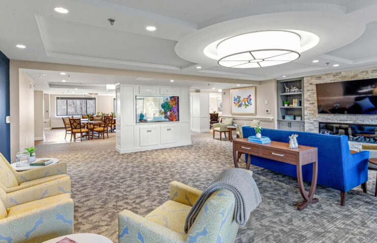 Bright, inviting communal lounge with comfortable seating, large aquarium, and dining area for socializing.