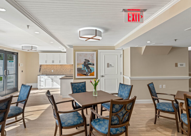 Bright, welcoming common area with seating, kitchenette, and artwork fostering community connection.