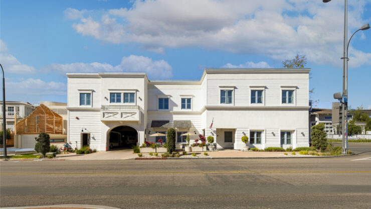 Bright, welcoming retirement home with outdoor seating and landscaped garden spaces promoting community and comfort.