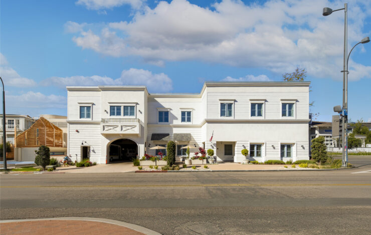Bright, welcoming retirement home with outdoor seating and landscaped garden spaces promoting community and comfort.