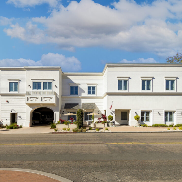 Bright, welcoming retirement home with outdoor seating and landscaped garden spaces promoting community and comfort.