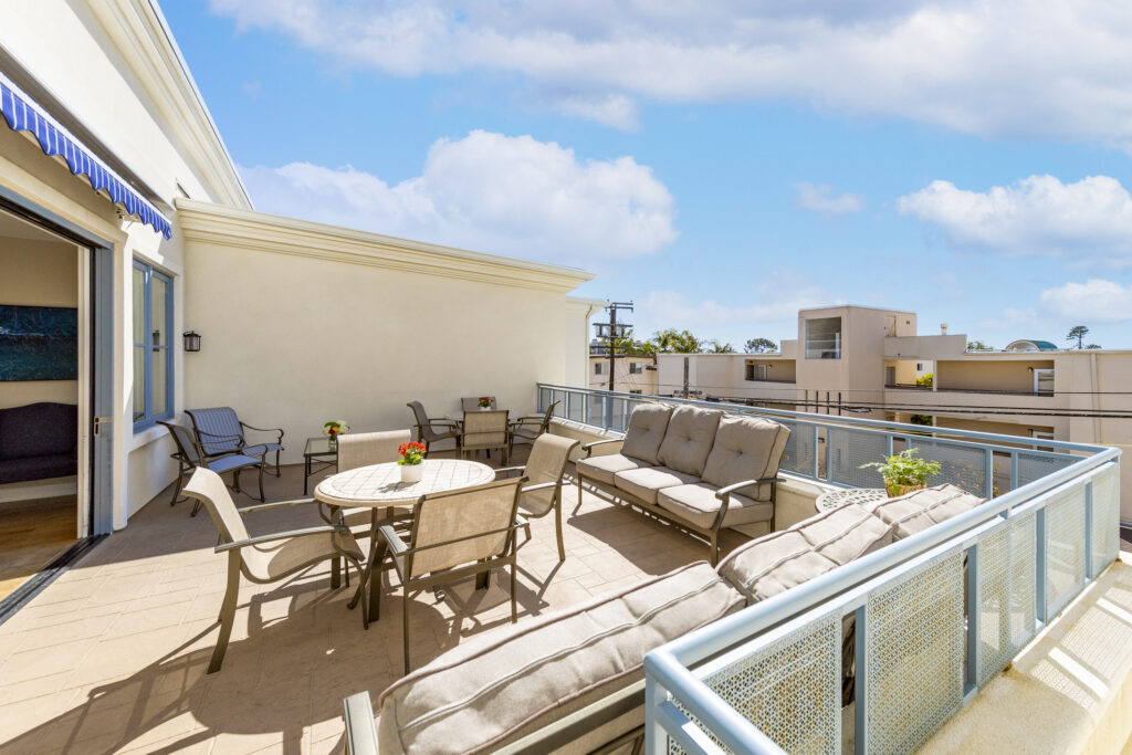 Spacious outdoor patio with comfortable seating and tables, perfect for social gatherings.