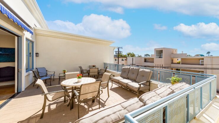 Spacious outdoor patio with comfortable seating and tables, perfect for social gatherings.
