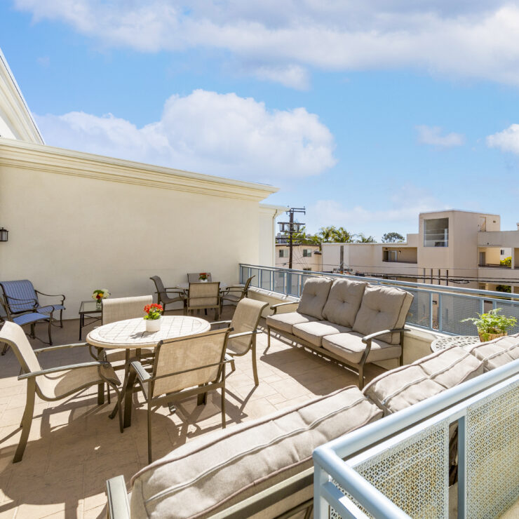 Spacious outdoor patio with comfortable seating and tables, perfect for social gatherings.