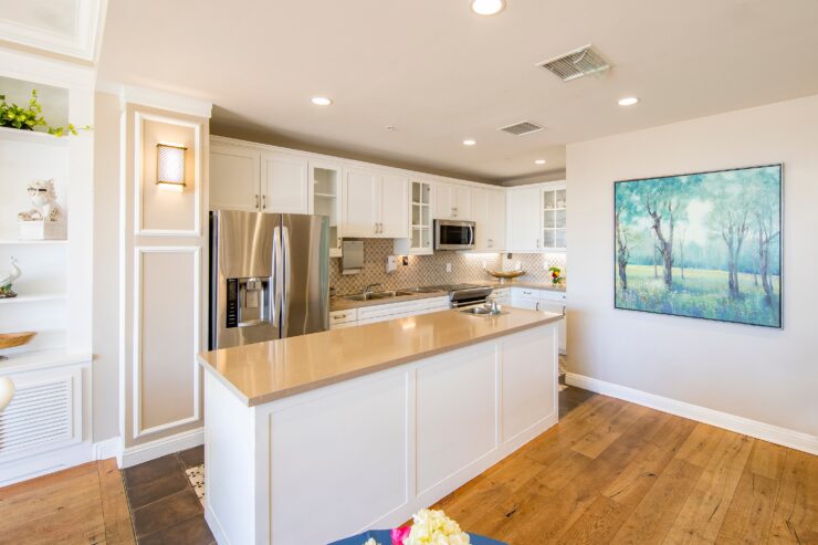 Bright and inviting kitchen with modern appliances and warm wooden floors for comfortable living.