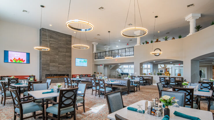 Spacious dining area with elegant seating, modern lighting, and a welcoming community atmosphere.
