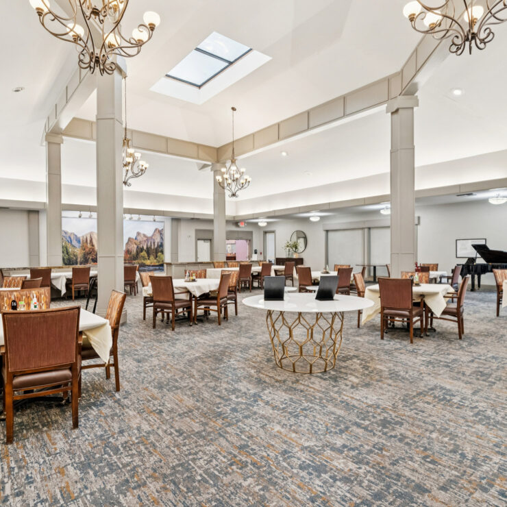 Bright dining room with spacious seating, elegant lighting, and a welcoming atmosphere for residents.