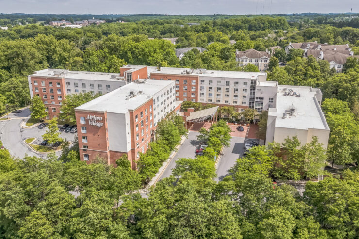 Retirement community surrounded by lush trees, offering a peaceful and welcoming environment.