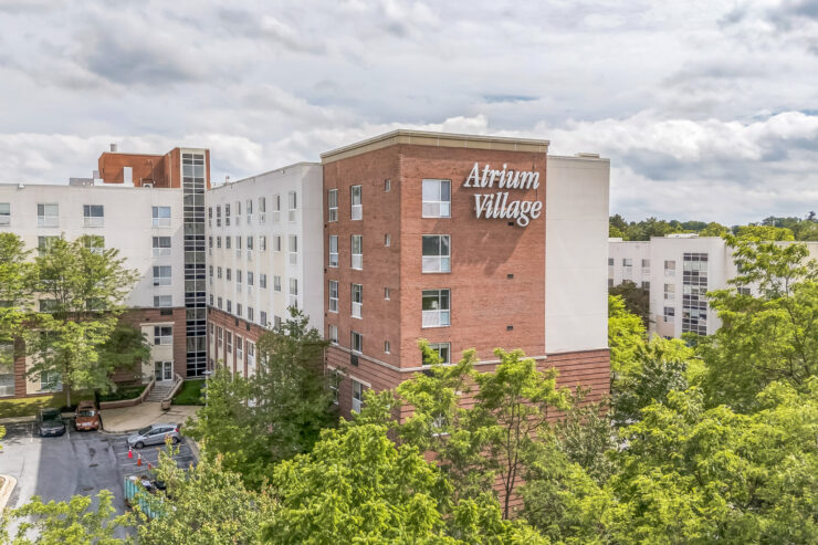 Atrium Village retirement home surrounded by trees, offering a peaceful community setting.