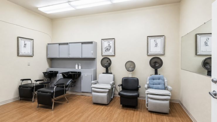 Salon area with comfortable chairs and hair-washing stations fostering social well-being.