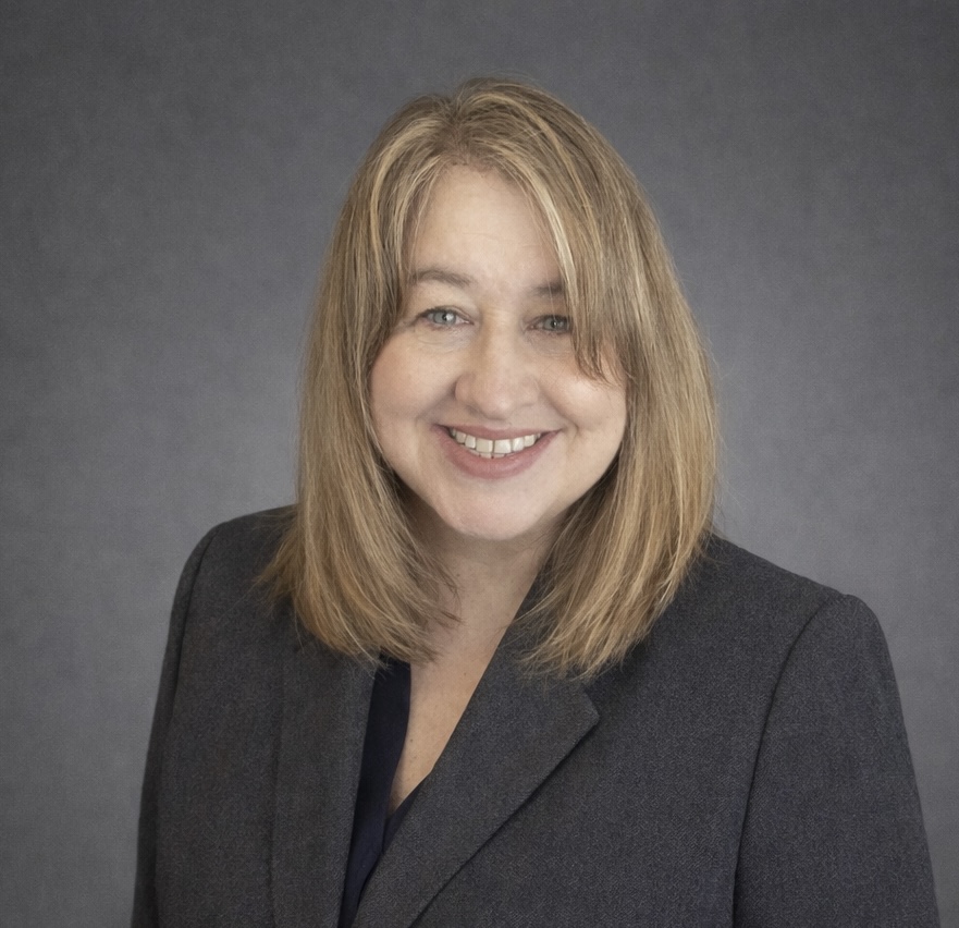 Friendly professional woman with warm smile, embodying trust and care in a supportive community.