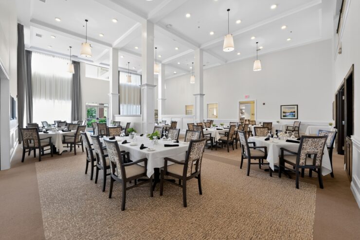 Bright and spacious dining room with elegant tables and comfortable seating for community gatherings.