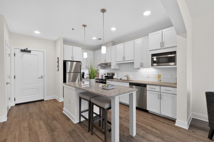 Bright, modern kitchen with a spacious island and seating, fostering a welcoming community space.