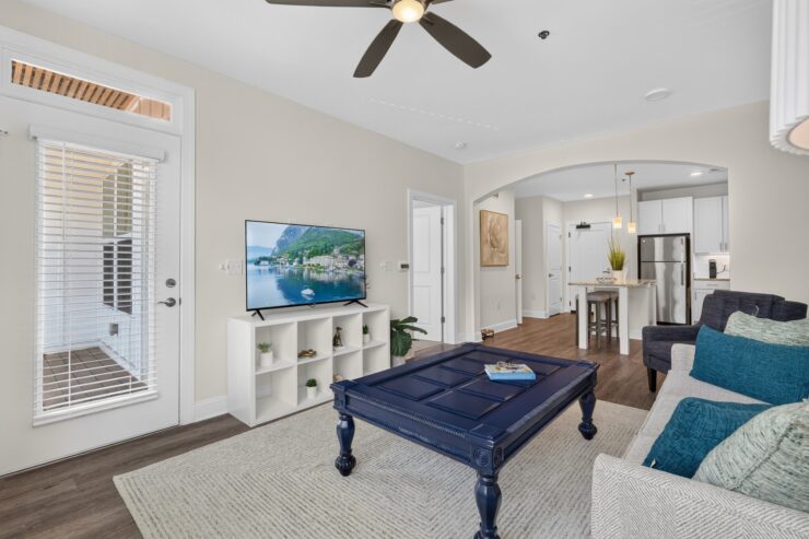 Bright living area with comfortable seating, a flat-screen TV, and an open kitchen for socializing.