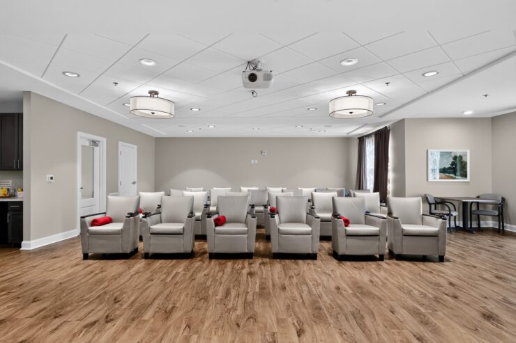 Bright, inviting community room with comfortable seating and soft lighting for group activities.