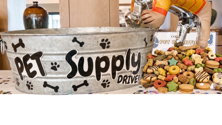 A pet supply drive display with colorful dog treats, creating a welcoming community atmosphere.