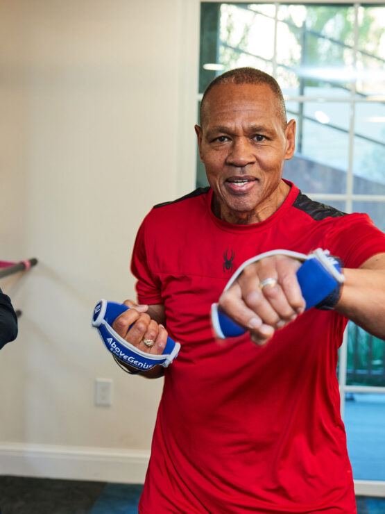 Two seniors engaging in a lively fitness session, fostering health and connection together.