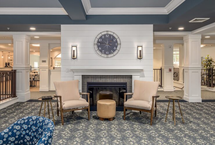 Welcoming lounge area with comfortable seating and a fireplace, designed for relaxed socializing.