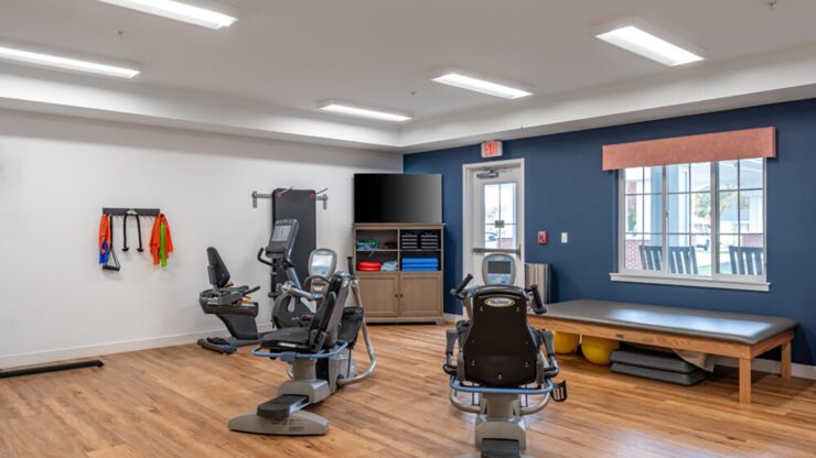 Bright fitness room with exercise equipment and natural light fostering active, healthy living.