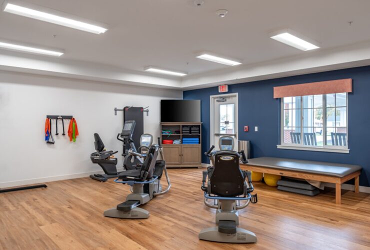 Bright fitness room with exercise equipment and natural light fostering active, healthy living.