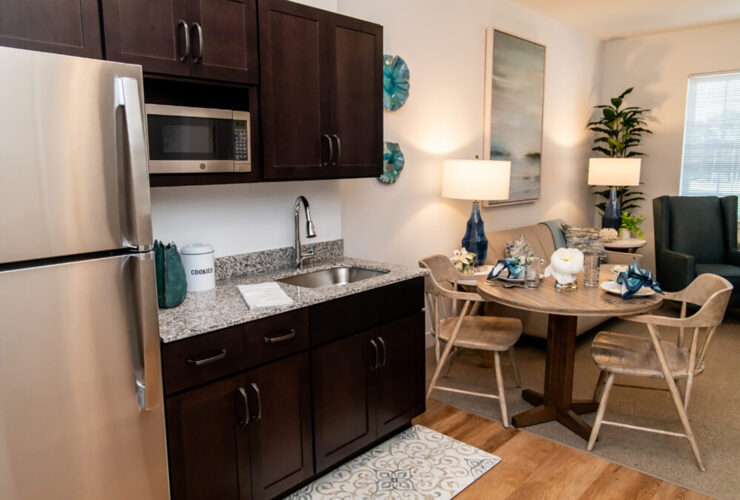 Modern kitchen and dining area with warm lighting, comfortable seating, and inviting decor.