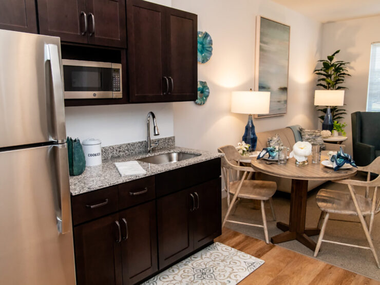 Modern kitchen and dining area with warm lighting, comfortable seating, and inviting decor.
