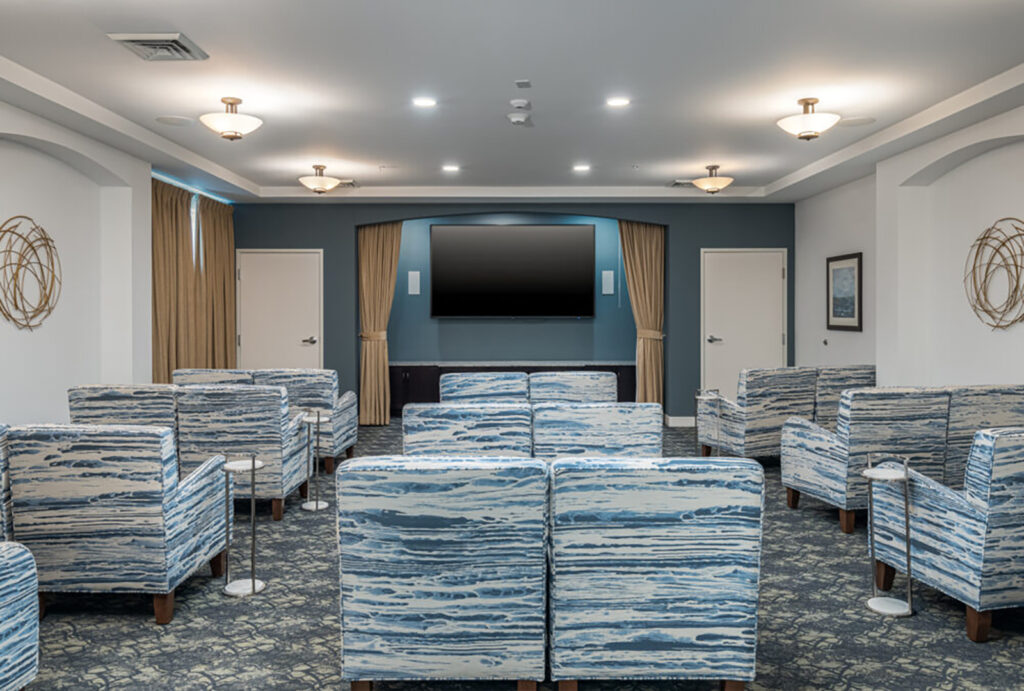 Spacious community room with comfortable seating and large TV for group activities and entertainment.