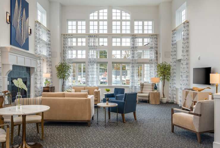 Bright and spacious lounge with comfortable seating, large windows, and welcoming decor for relaxing social time.