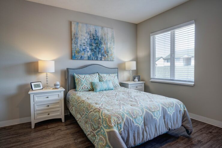 Well-lit bedroom with elegant bedding, bedside lamps, and inviting decor for restful comfort.