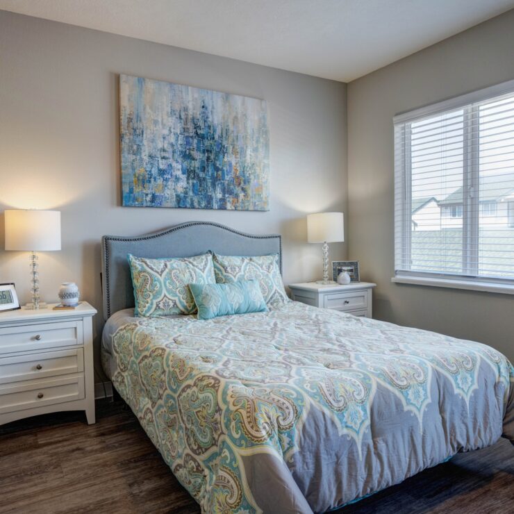 Well-lit bedroom with elegant bedding, bedside lamps, and inviting decor for restful comfort.