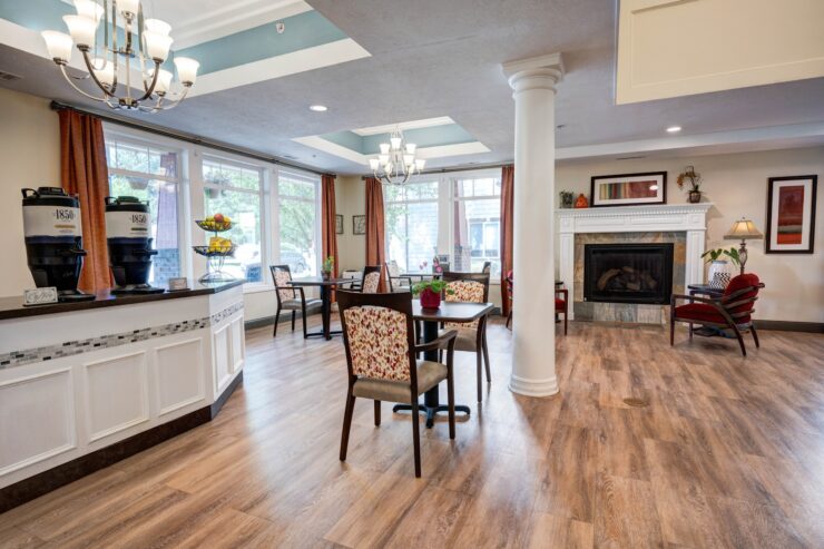 Bright, inviting community space with seating, coffee station, and fireplace for social gatherings.