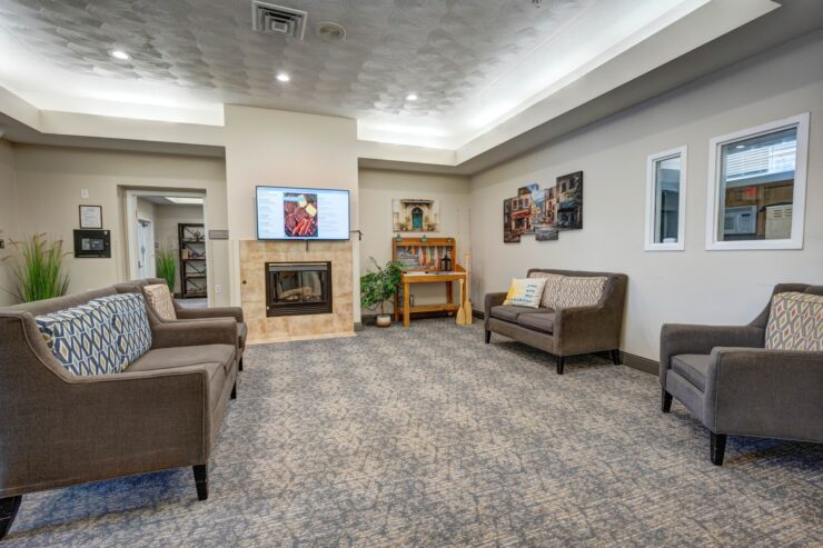 Spacious lounge with comfortable seating, warm fireplace, and inviting community atmosphere.