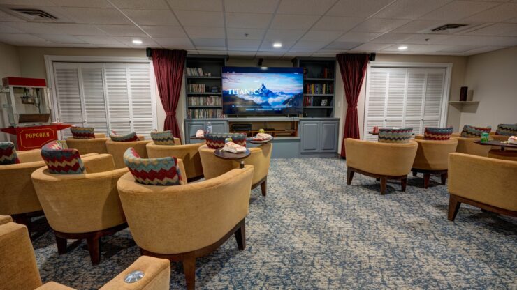 Comfortable theater room with plush seating, a large screen, and a popcorn machine for shared enjoyment.