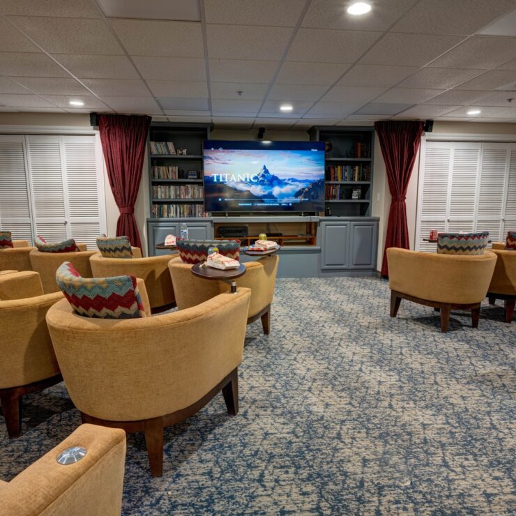 Comfortable theater room with plush seating, a large screen, and a popcorn machine for shared enjoyment.