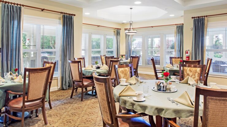 Dining area with elegant wooden chairs, soft lighting, and welcoming table settings.
