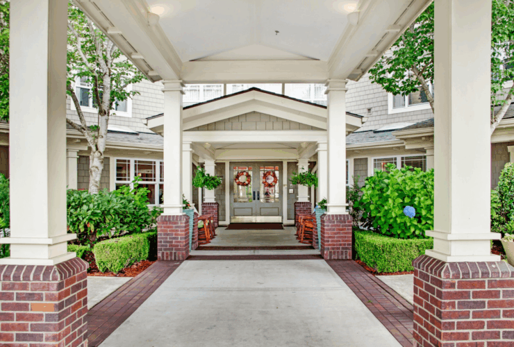 Welcoming entrance with rocking chairs and vibrant greenery, inviting a sense of community and comfort.