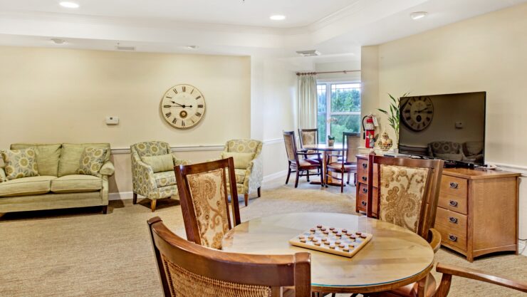 Warm and inviting game room featuring comfortable seating and natural light for social gatherings.