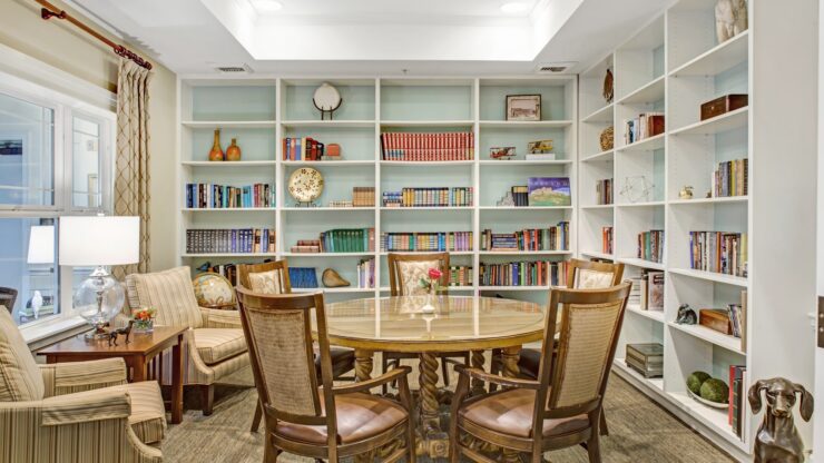 Inviting library space with comfortable seating, bookshelves, and natural light for community gatherings.