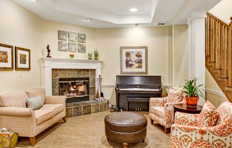Inviting living area with fireplace, piano, and comfortable seating for social gatherings.
