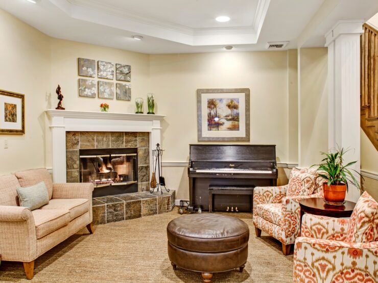 Inviting living area with fireplace, piano, and comfortable seating for social gatherings.