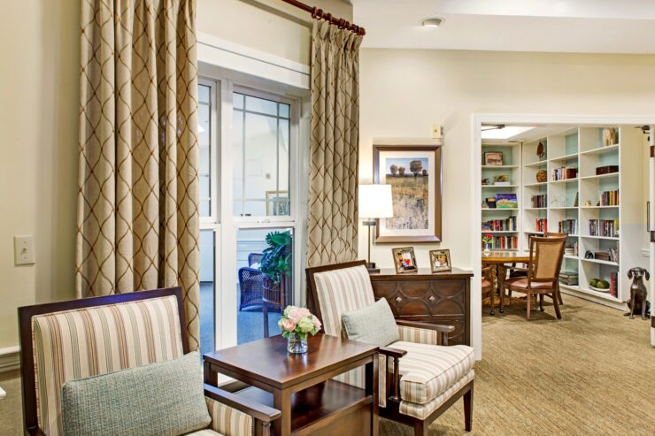Inviting seating area with soft lighting and bookshelves, fostering a warm community atmosphere.