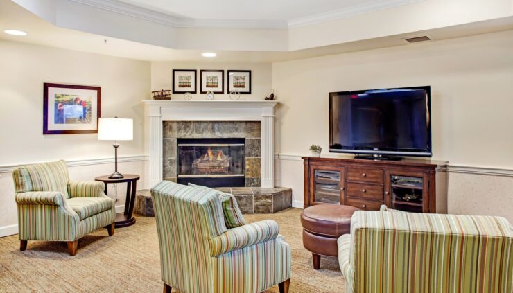 Warm seating area with fireplace, TV, and soft lighting designed for shared relaxation.